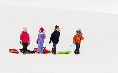 Image showing happy little kids with sleds in winter