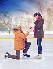 Image showing man with ring making proposal on skating rink