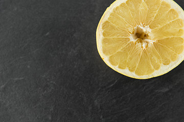 Image showing close up of lemon slice on slate table top