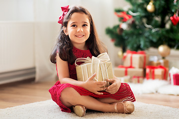 Image showing happy girl with christmas gift at home