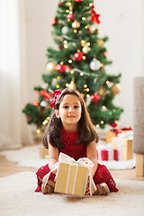 Image showing happy girl with christmas gift at home