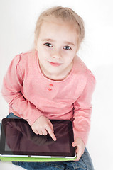 Image showing Little girl uses a tablet PC