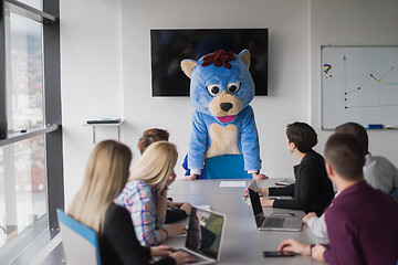 Image showing boss dresed as bear having fun with business people in trendy of