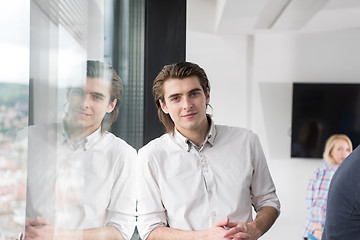 Image showing young businessman in startup office by the window