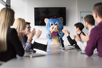 Image showing boss dresed as bear having fun with business people in trendy of