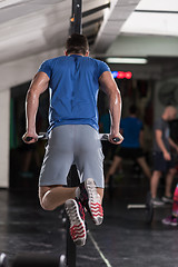 Image showing man doing exercises parallel bars