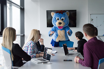 Image showing boss dresed as bear having fun with business people in trendy of