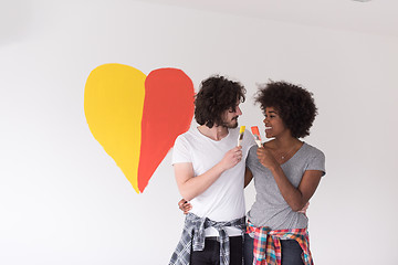 Image showing couple with painted heart on wall