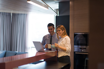 Image showing A young couple is preparing for a job and using a laptop