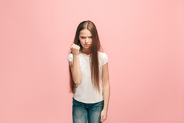 Image showing Portrait of angry teen girl on a pink studio background