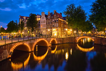 Image showing Amterdam canal, bridge and medieval houses in the evening