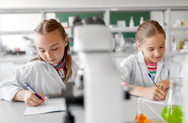 Image showing two girls studying chemistry at school laboratory