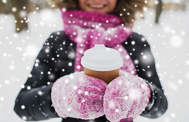 Image showing close up of hand with coffee outdoors in winter