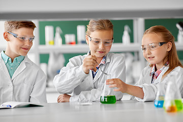 Image showing kids with test tube studying chemistry at school