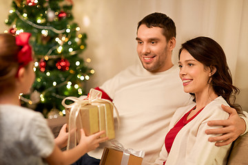 Image showing happy family with christmas present at home