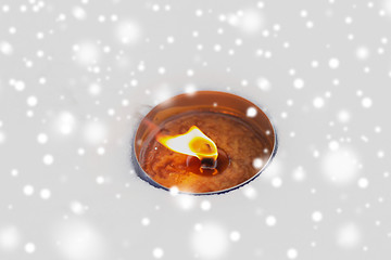 Image showing christmas outdoor candle burning on snow in winter