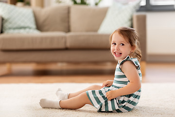 Image showing happy baby girl sitting on floor at home