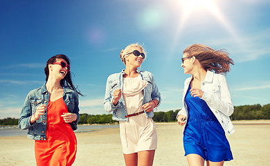 Image showing group of smiling women in sunglasses on beach