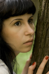 Image showing girl hiding behind a tree