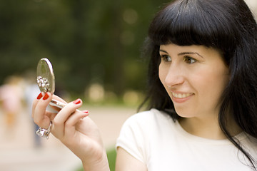 Image showing girl looking in the mirror