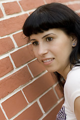 Image showing girl against brick wall