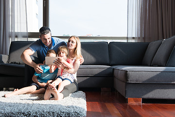 Image showing happy young couple spending time with kids