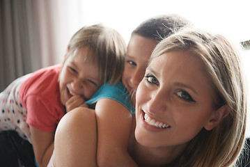 Image showing young mother spending time with kids on the floor