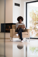 Image showing black woman at home reading book