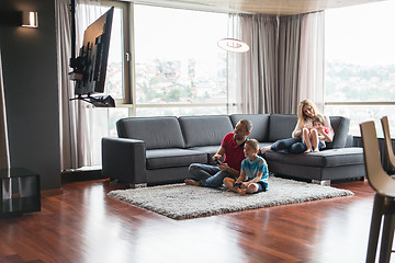 Image showing Happy family playing a video game