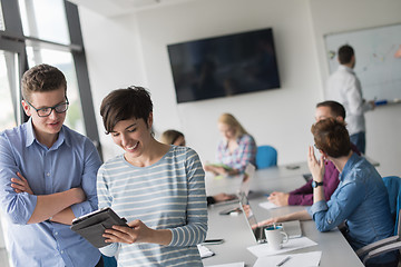 Image showing Two Business People Working With Tablet in office