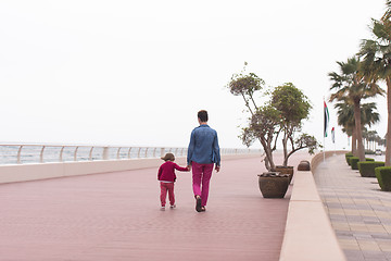 Image showing mother and cute little girl on the promenade by the sea