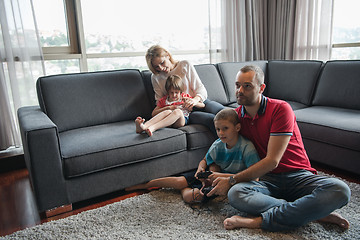 Image showing Happy family playing a video game