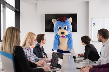 Image showing boss dresed as bear having fun with business people in trendy of