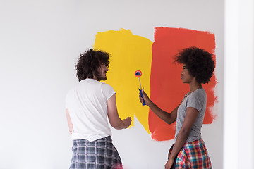 Image showing multiethnic couple painting interior wall