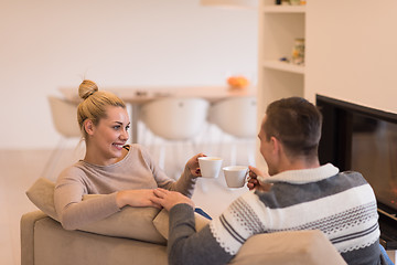 Image showing Young couple  in front of fireplace