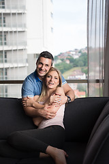 Image showing young handsome couple hugging on the sofa