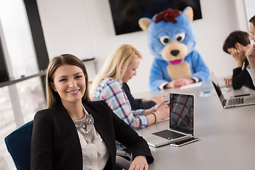 Image showing boss dresed as bear having fun with business people in trendy of