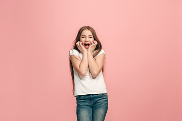 Image showing Beautiful teen girl looking suprised isolated on pink