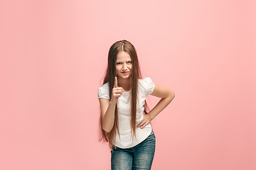 Image showing Beautiful female half-length portrait on pink studio backgroud. The young emotional teen girl