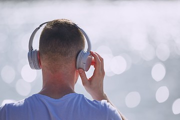 Image showing Young man with headphones listening