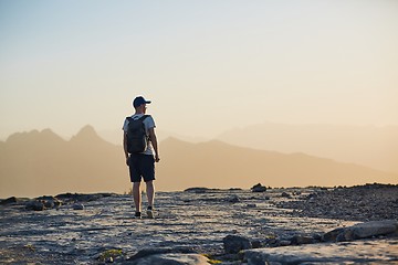 Image showing Tourist in mountain at sunset