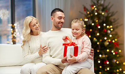 Image showing happy family at home with christmas gift