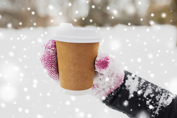 Image showing close up of hand with coffee outdoors in winter