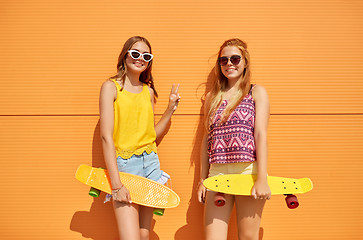 Image showing teenage girls with short skateboards outdoors