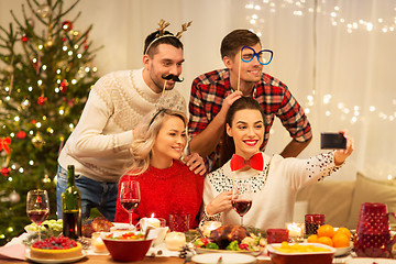 Image showing friends taking selfie at christmas dinner