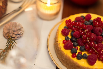 Image showing close up of berry cake on christmas table at home