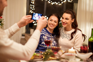 Image showing friends having christmas dinner and taking picture