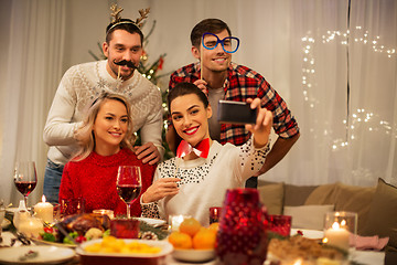 Image showing friends taking selfie at christmas dinner