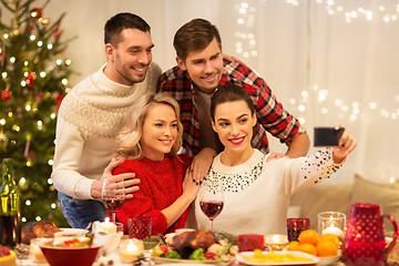 Image showing friends taking selfie at christmas dinner