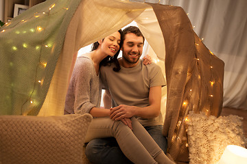 Image showing happy couple in kids tent at home